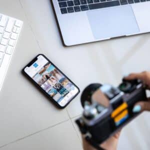 Camera pointing at mobile phone on desk. 